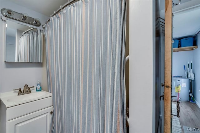 bathroom with vanity, wood finished floors, and water heater