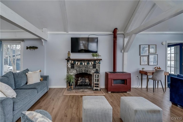 living area featuring a wealth of natural light, lofted ceiling with beams, and wood finished floors