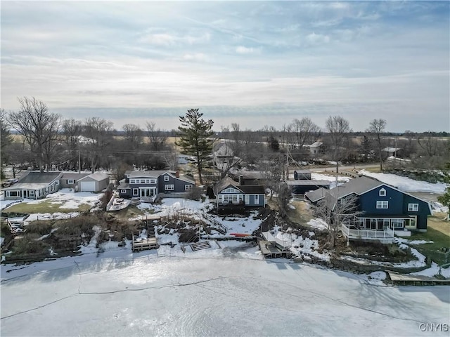 snowy aerial view featuring a residential view