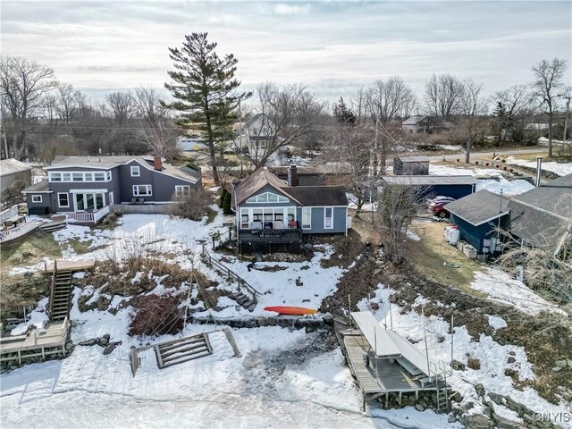 snowy aerial view with a residential view