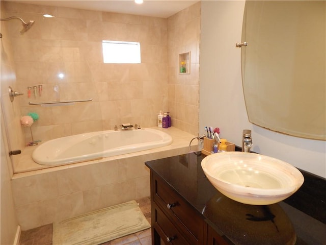 full bathroom with tile patterned floors, vanity, and tiled shower / bath combo