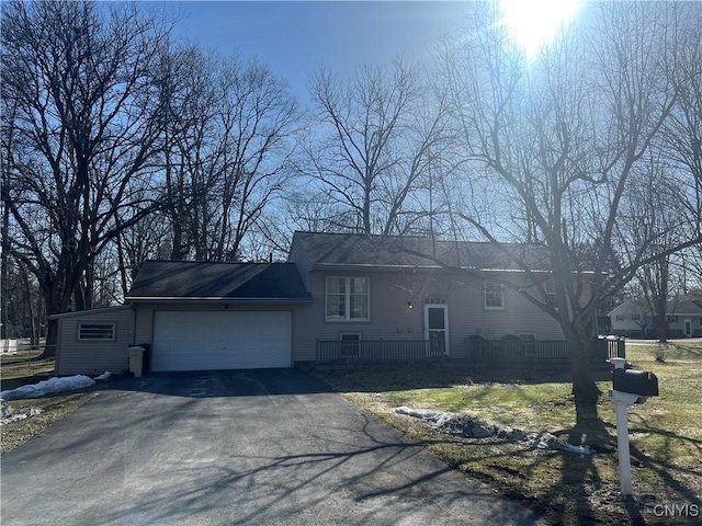 view of front of property featuring aphalt driveway and an attached garage