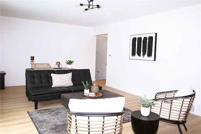 living room featuring light wood-style floors and visible vents