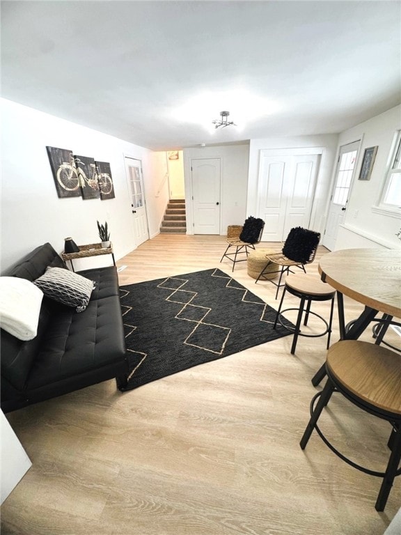 living area with wood finished floors and stairs