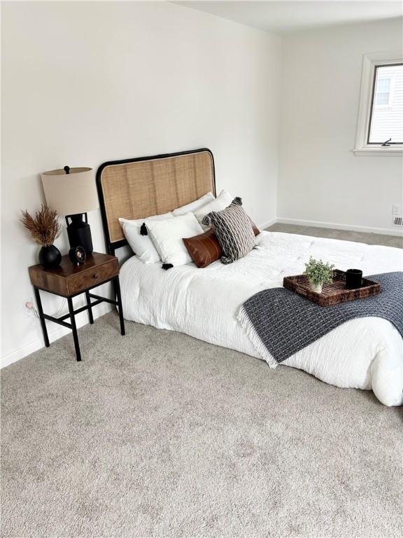 bedroom featuring carpet flooring and baseboards