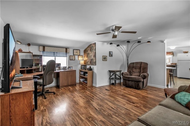 home office featuring wood finished floors, baseboards, and ceiling fan