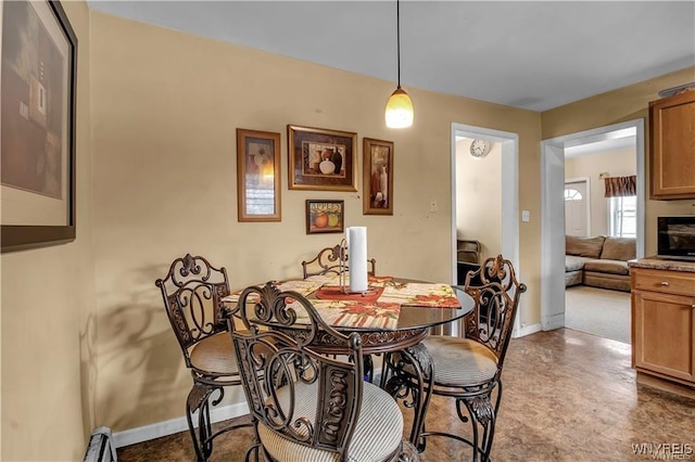 dining area featuring baseboards