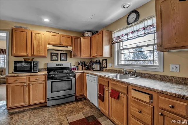 kitchen featuring a sink, under cabinet range hood, black microwave, dishwasher, and stainless steel gas range