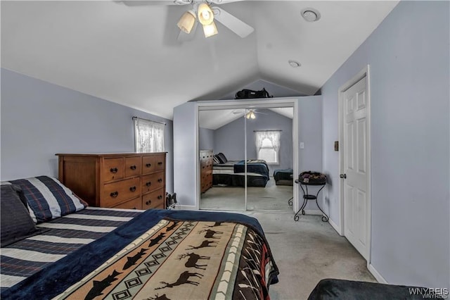 carpeted bedroom with a closet, baseboards, a ceiling fan, and lofted ceiling