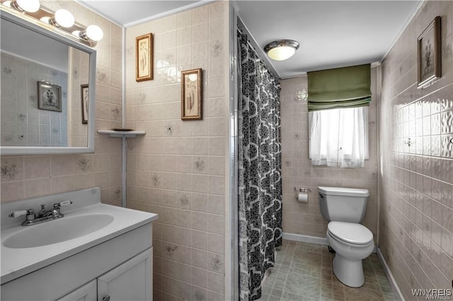 full bathroom featuring vanity, tile walls, toilet, and tile patterned floors