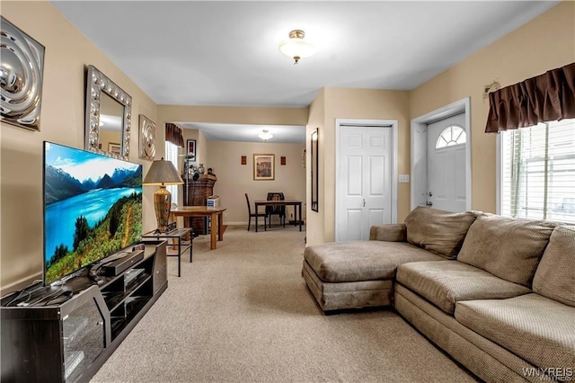 carpeted living room featuring baseboards