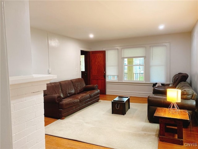 living area with recessed lighting, baseboards, and wood finished floors