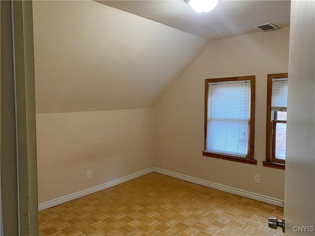 bonus room featuring visible vents, lofted ceiling, and baseboards