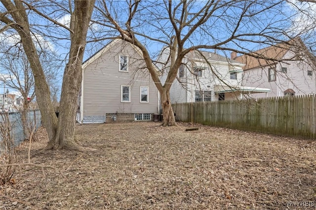 back of house featuring fence