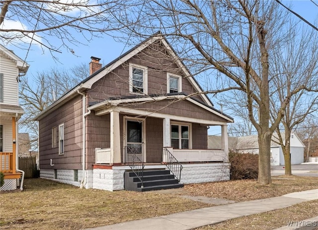 view of front of home with a porch and a chimney