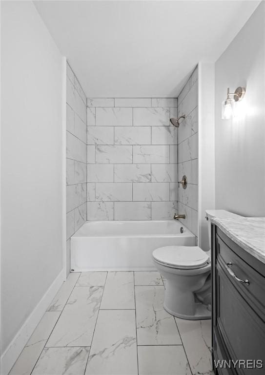 full bathroom with baseboards, toilet, bathing tub / shower combination, marble finish floor, and vanity