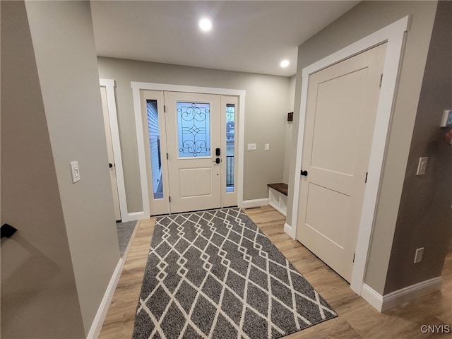 foyer featuring recessed lighting, baseboards, and light wood-style floors