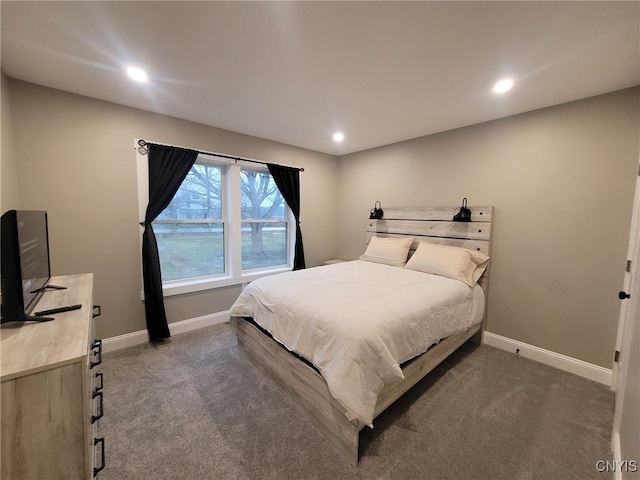 bedroom with recessed lighting, dark carpet, and baseboards