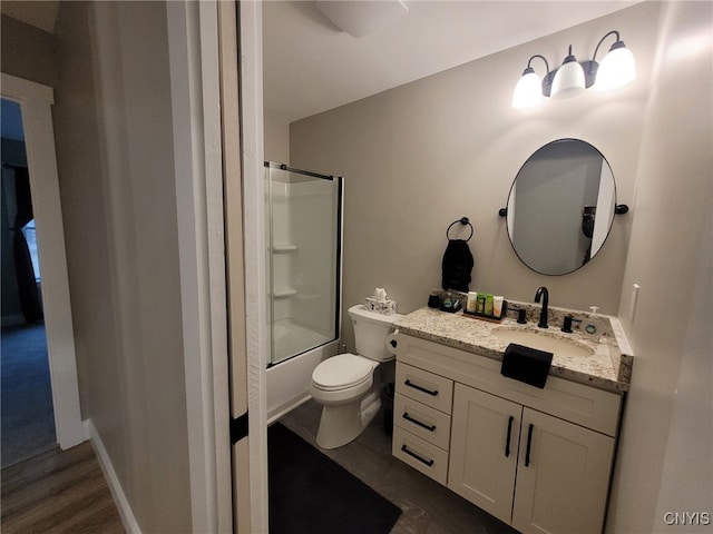 full bath featuring shower / bath combination with glass door, toilet, and vanity