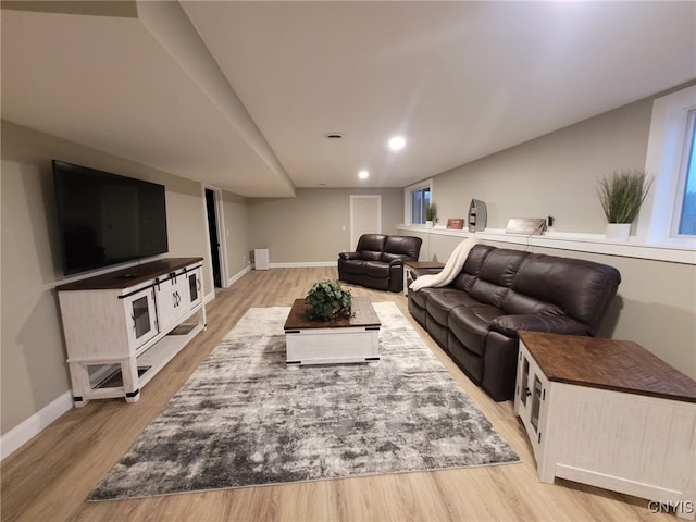 living area with recessed lighting, baseboards, and light wood-style floors