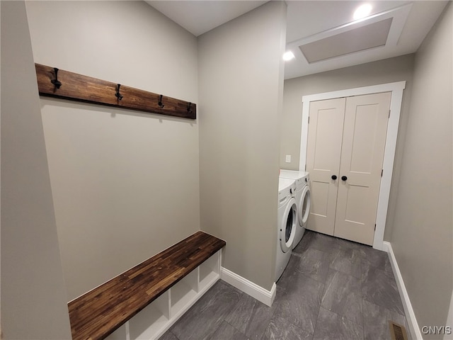 laundry area with laundry area, baseboards, visible vents, and washer and clothes dryer