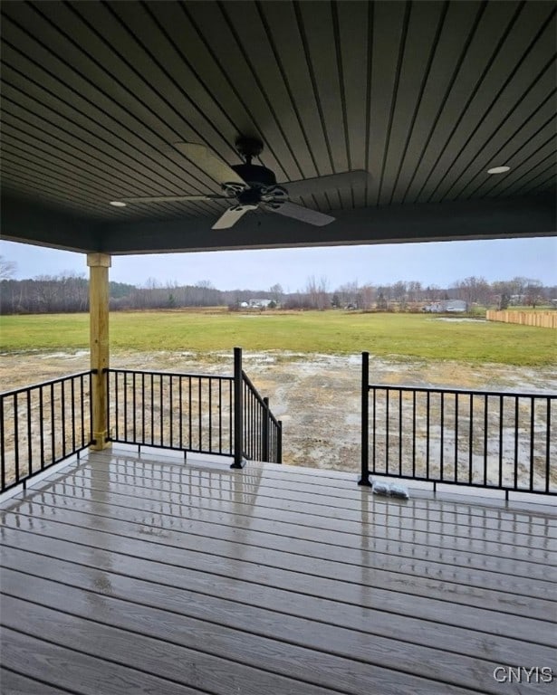 deck featuring a rural view and ceiling fan