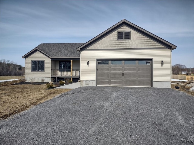 view of front of home featuring an attached garage, roof with shingles, and driveway