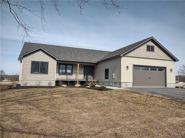 view of front of property featuring a porch, an attached garage, driveway, and roof with shingles