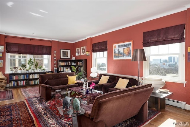 living room with wood finished floors, baseboards, and a baseboard radiator