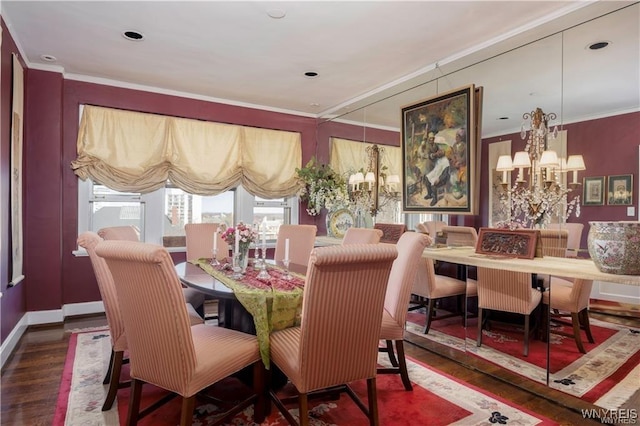 dining area featuring baseboards, wood finished floors, a chandelier, and ornamental molding