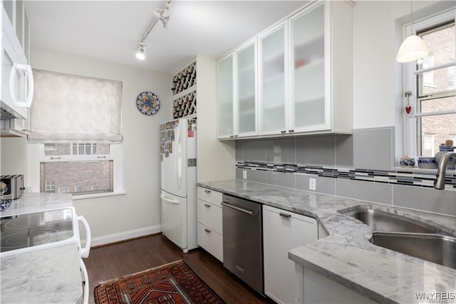 kitchen with dark wood-type flooring, a sink, tasteful backsplash, white cabinetry, and white appliances