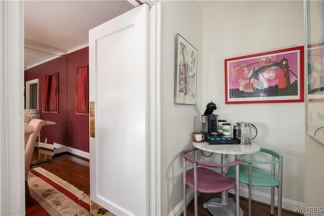 hall with baseboards and wood finished floors