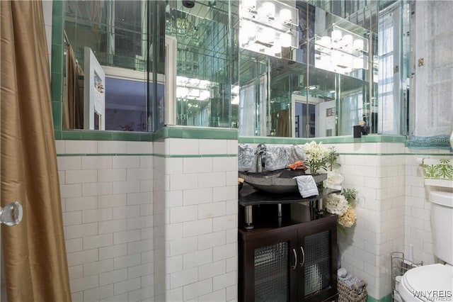 bathroom featuring toilet and tile walls