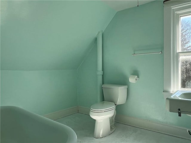 bathroom featuring vaulted ceiling, toilet, and baseboards