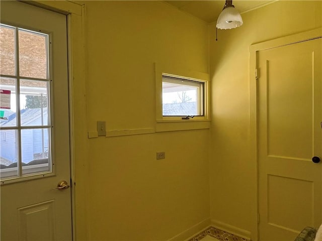 laundry area featuring baseboards