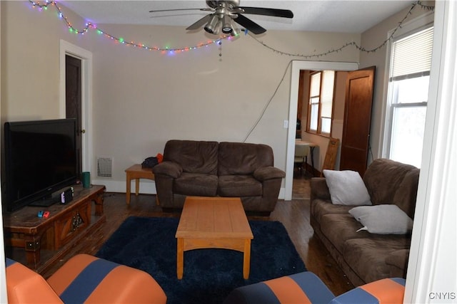 living area featuring visible vents, wood finished floors, and a ceiling fan