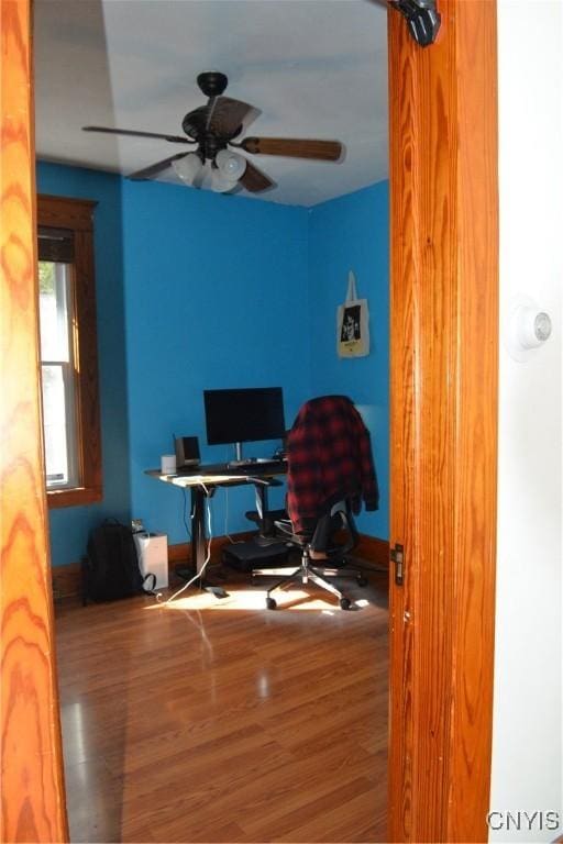 home office featuring wood finished floors, baseboards, and ceiling fan