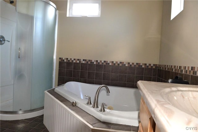 full bath featuring tile patterned flooring, a shower stall, a bath, and vanity