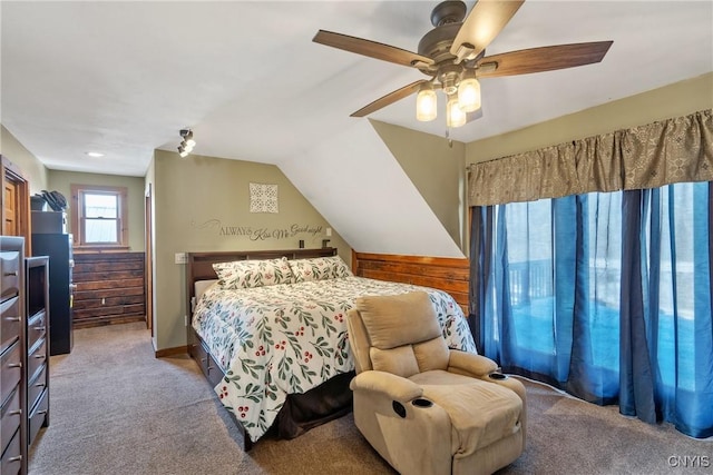 carpeted bedroom with ceiling fan and vaulted ceiling