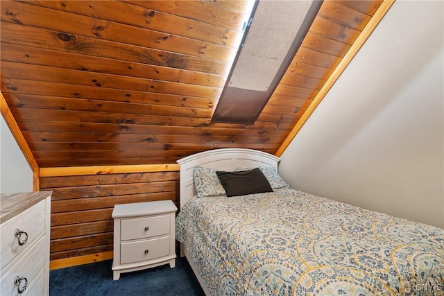 bedroom featuring vaulted ceiling, wood walls, wood ceiling, and dark colored carpet