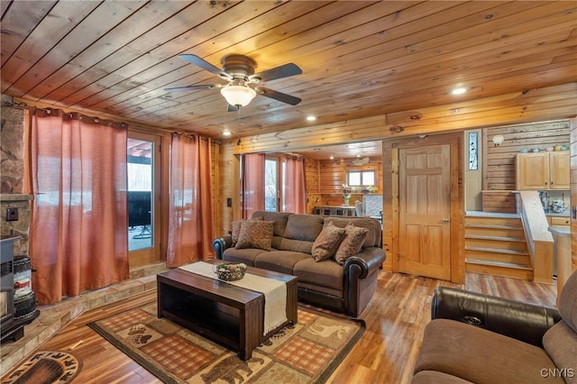 living area with recessed lighting, ceiling fan, light wood-style floors, wood walls, and wooden ceiling