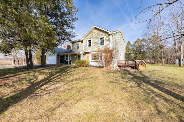 traditional home with a garage, a deck, and a front yard