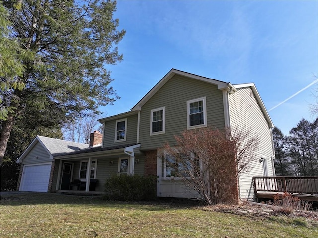 traditional home featuring an attached garage, a chimney, and a front lawn