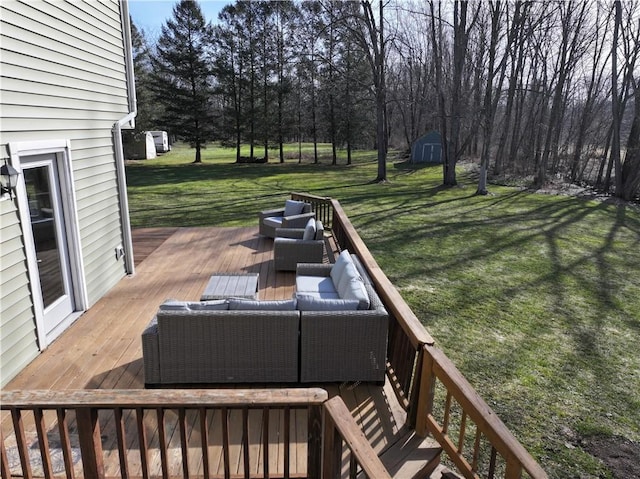 deck featuring a shed, outdoor lounge area, a yard, and an outdoor structure