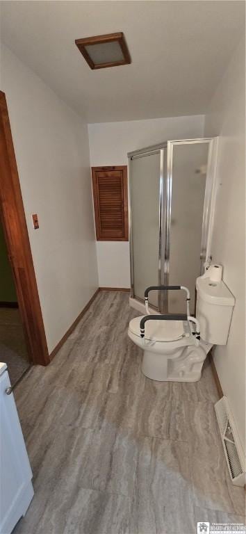 full bathroom with visible vents, toilet, a stall shower, wood finished floors, and baseboards