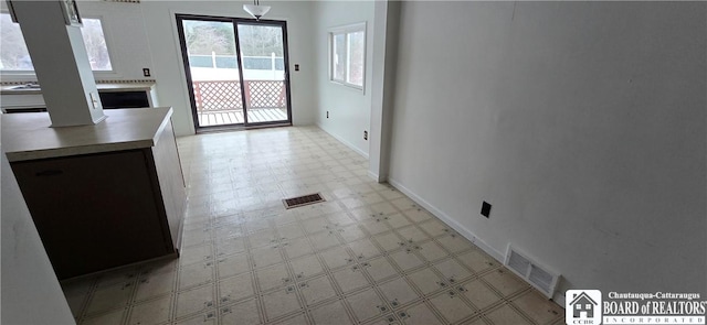 interior space with visible vents, light floors, and baseboards