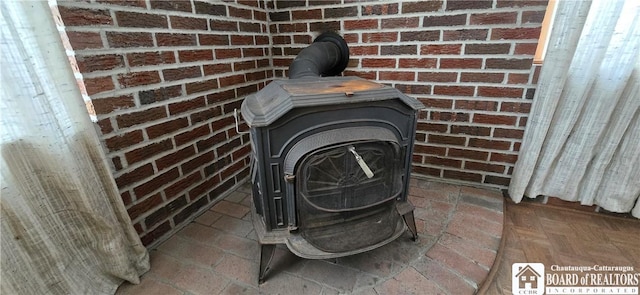 exterior details featuring brick siding and a wood stove