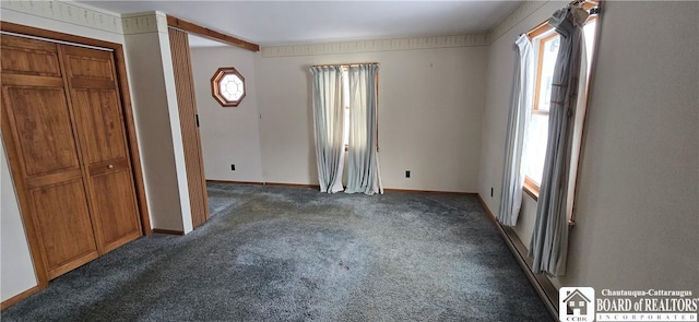 unfurnished bedroom with carpet flooring and baseboards