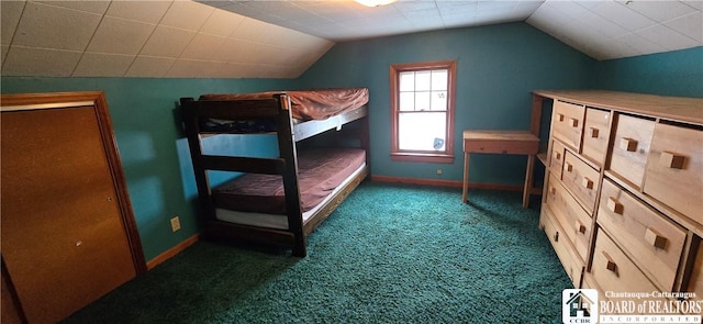 carpeted bedroom featuring baseboards and vaulted ceiling