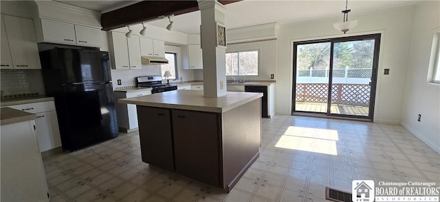 1620 Haskell Rd, Portville, NY 14760 - kitchen featuring light floors, exhaust hood, stainless steel gas range, and freestanding refrigerator